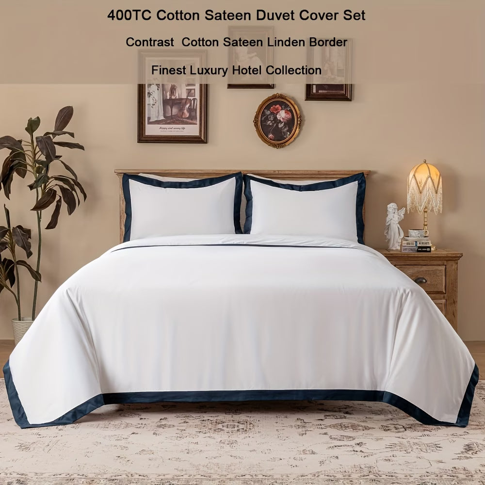 White duvet cover set with blue border on a bed in a bedroom setting.