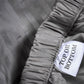 Close-up of a label on a piece of fabric with text 'TOP OR BOTTOM'.