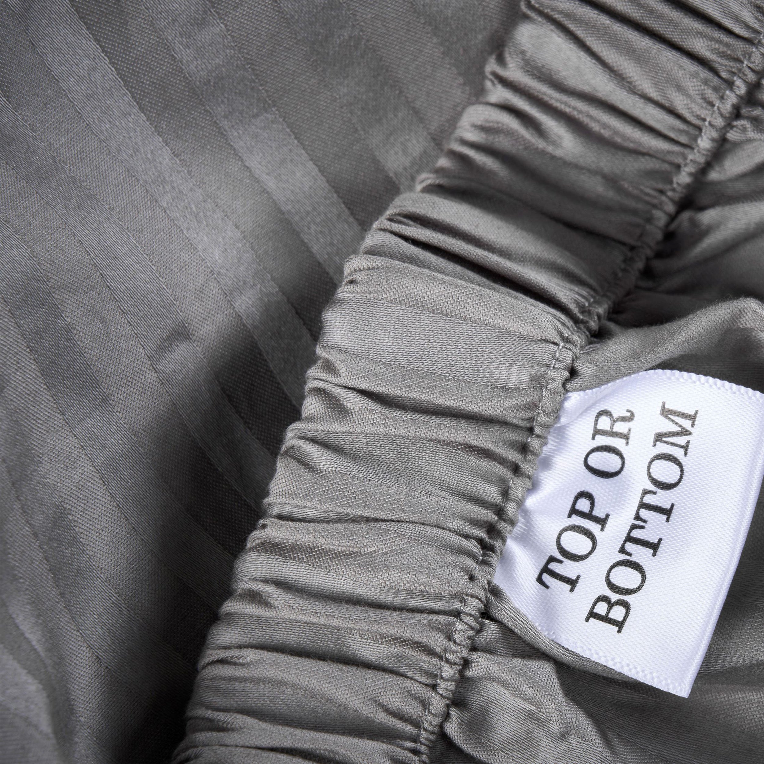 Close-up of a label on a piece of fabric with text 'TOP OR BOTTOM'.