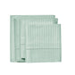 Set of light green folded towels on a white background