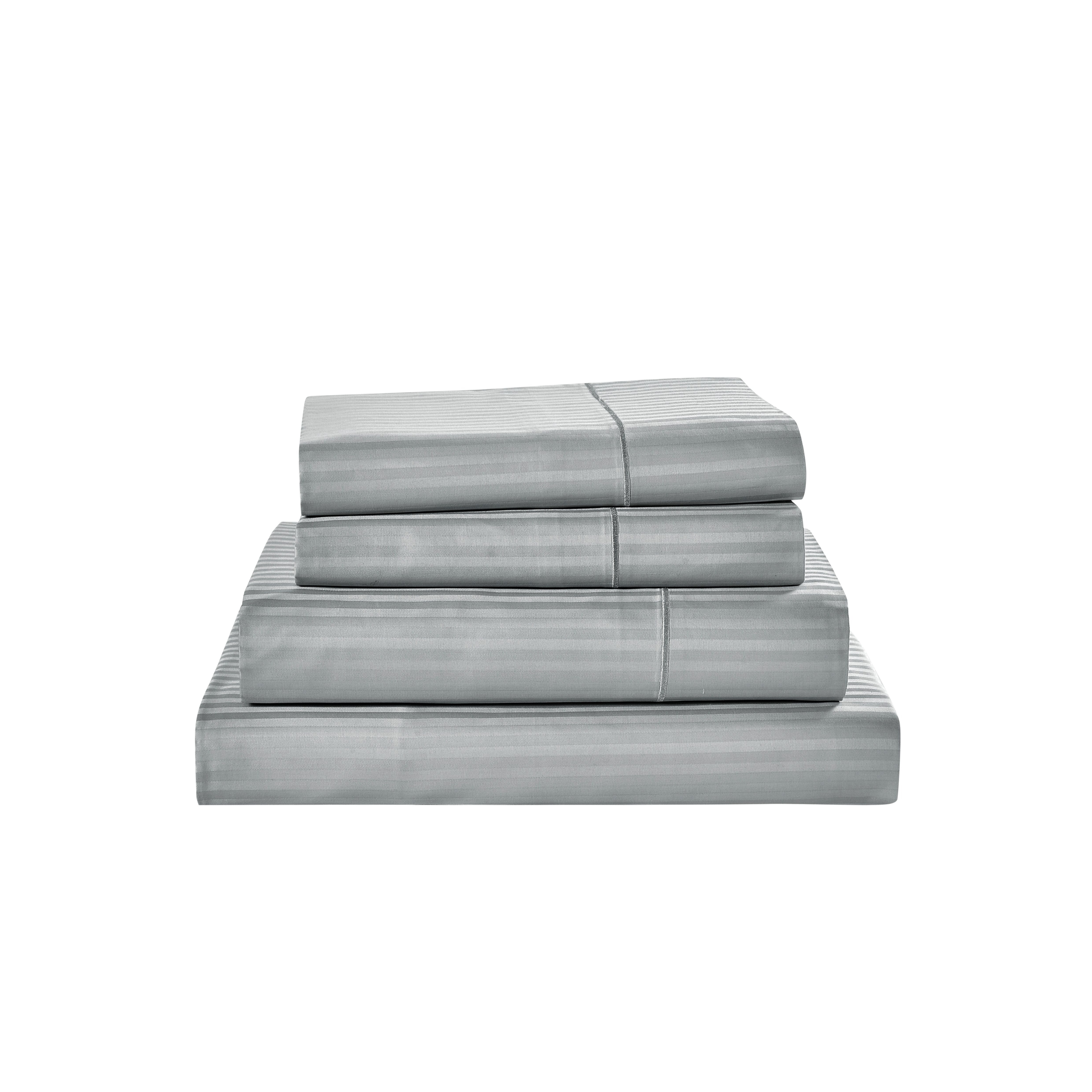 Stack of gray striped bed sheets on a white background