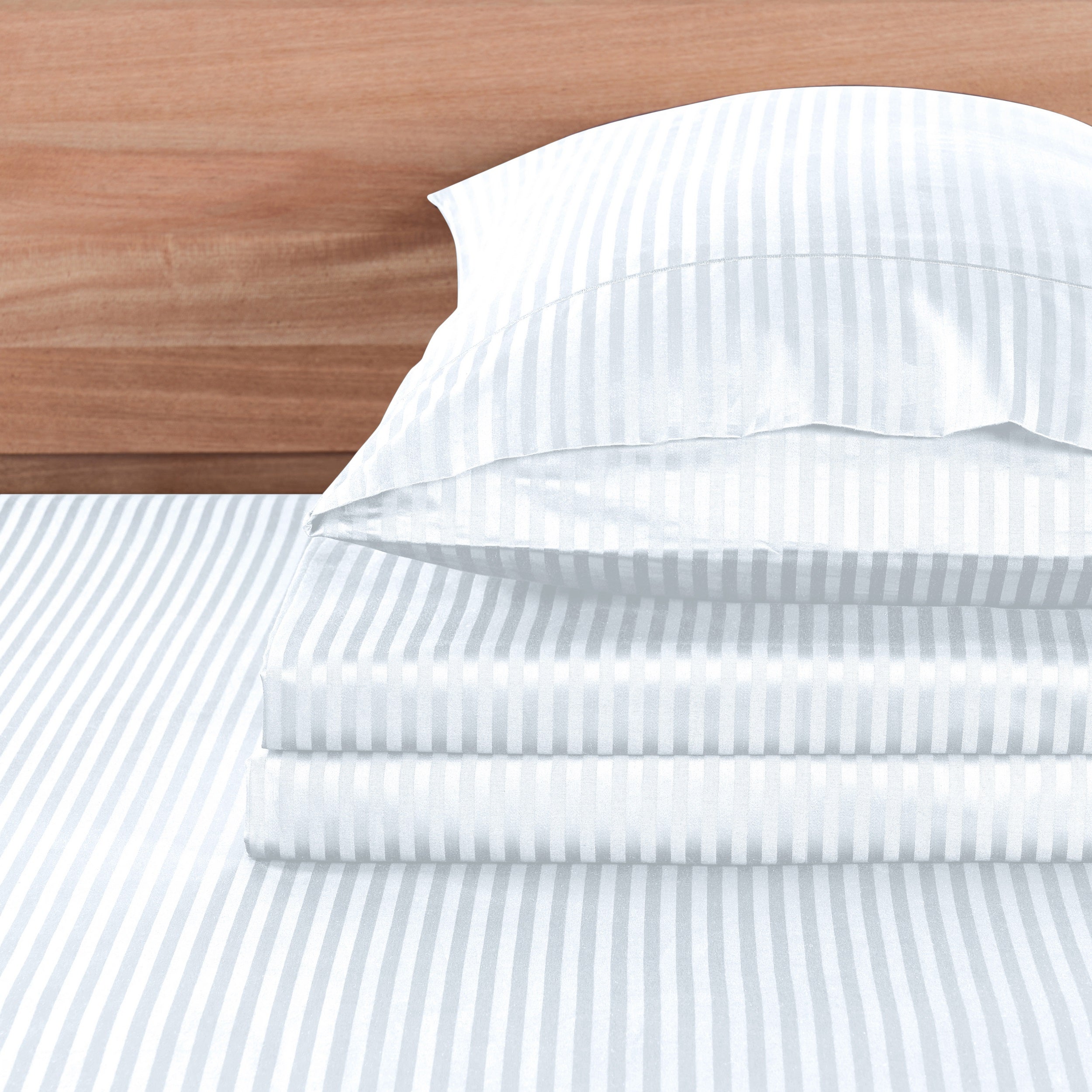 White striped bed sheets and pillowcase set on a wooden headboard background