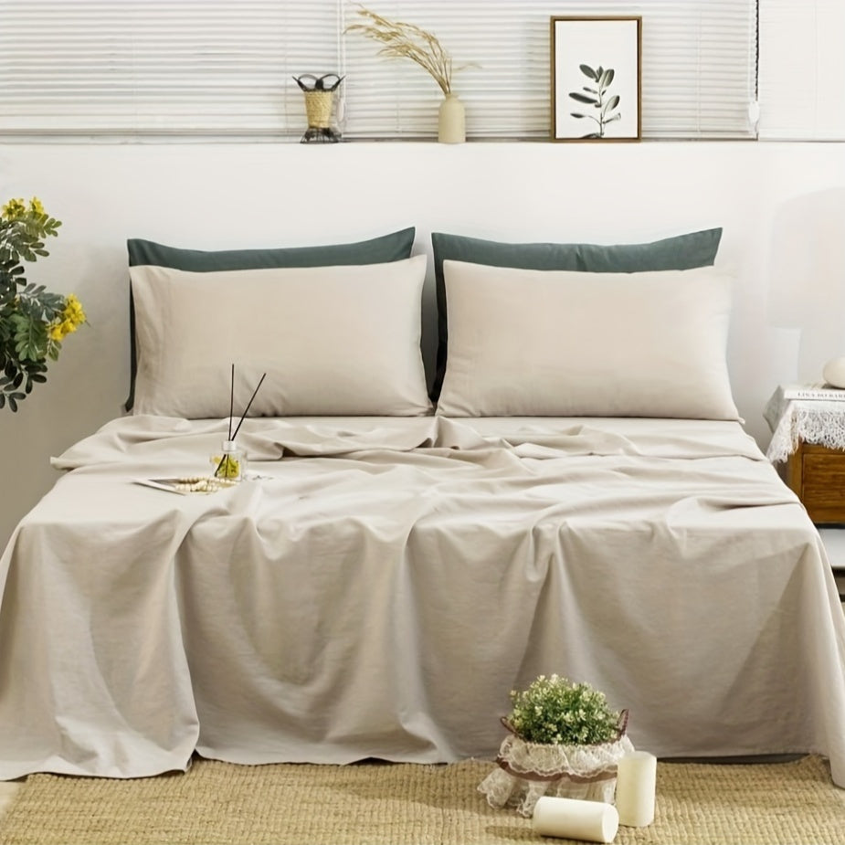 Neatly made bed with beige bedding and green pillows in a bedroom setting.