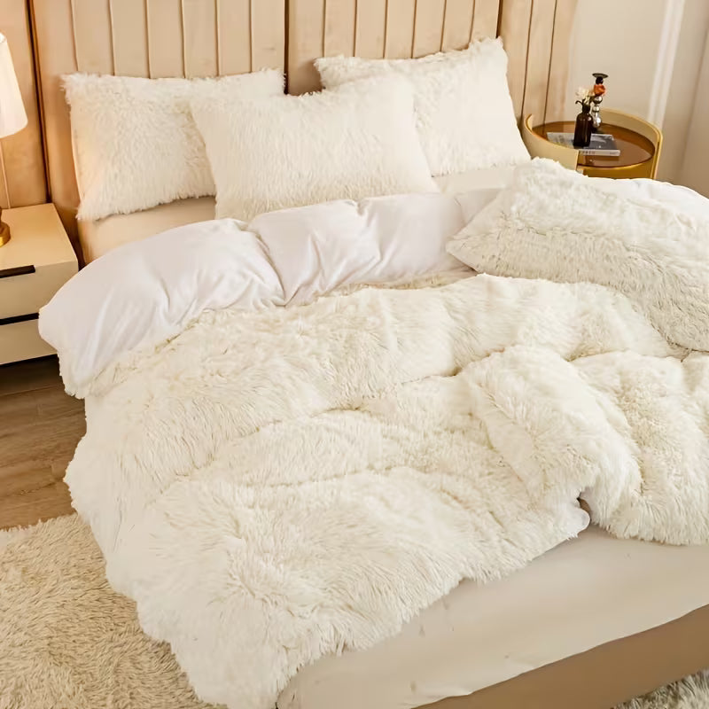 Fluffy white bedding set on a bed in a bedroom setting.