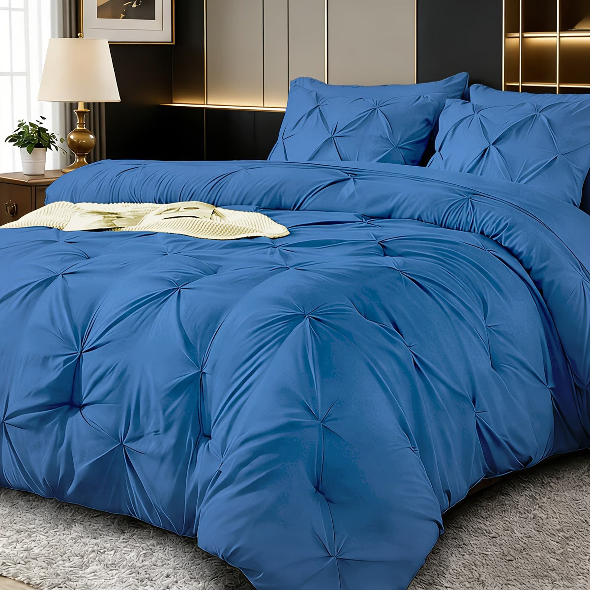 Blue textured comforter set on a bed in a bedroom setting.