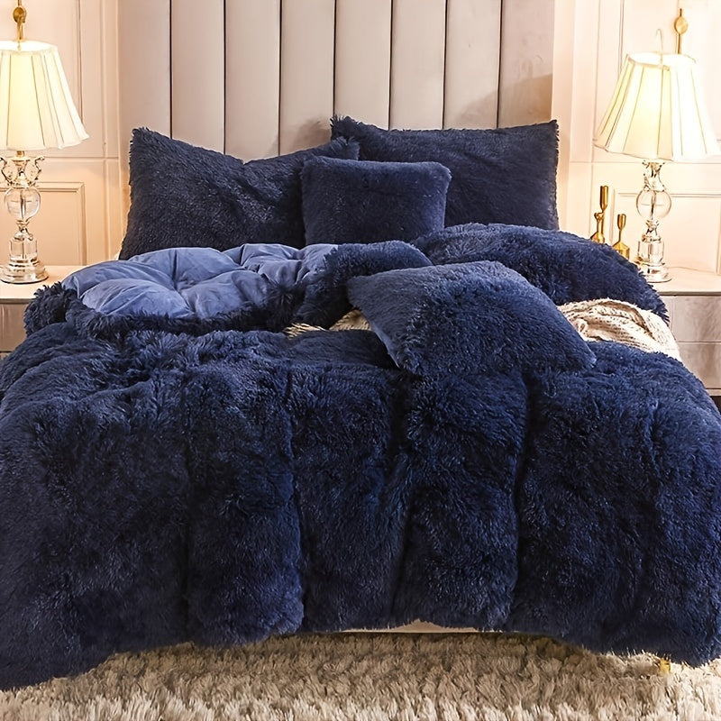 Navy blue fuzzy comforter set on a bed with pillows in a bedroom setting.
