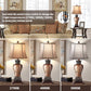Table lamp with metal rotary switch for changing light temperatures in a living room setting.