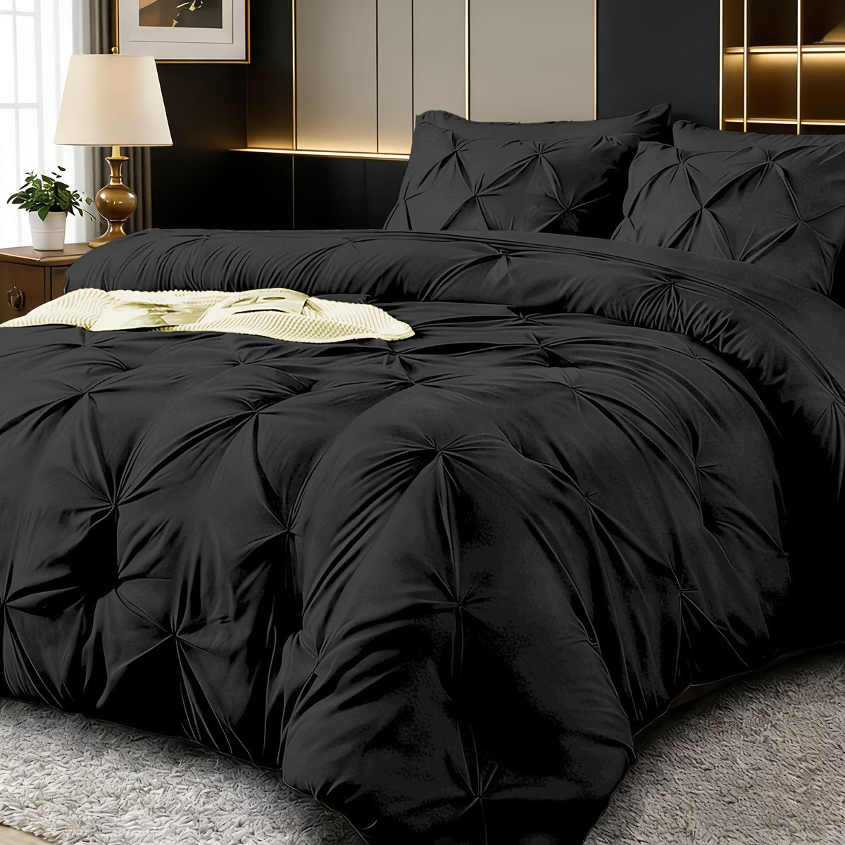 Black textured comforter set on a bed in a stylish bedroom.