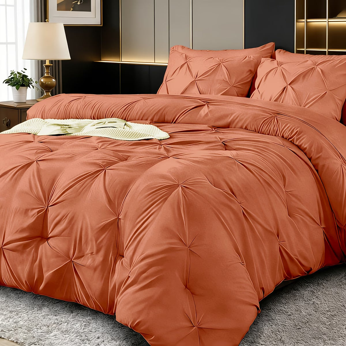 Orange quilted comforter set on a bed in a bedroom setting.