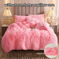 Pink fluffy comforter set without comforter or pillow core on a bed.