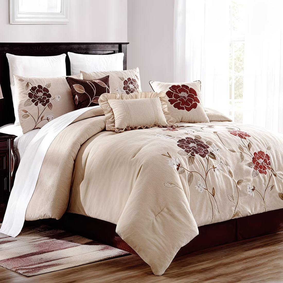 Neatly made bed with floral patterned bedding in a bright bedroom.