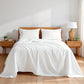 Bedroom with a wooden bed, white bedding, and wooden nightstands.