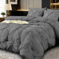 Gray textured comforter set on a bed in a bedroom setting with decorative elements.