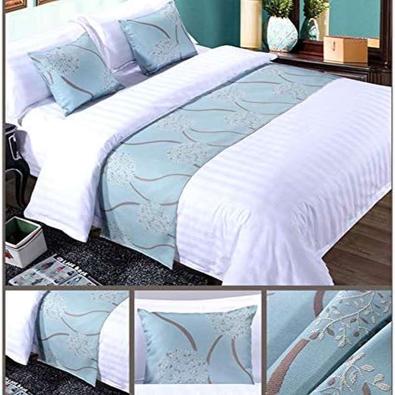 Bed with white bedding and light blue decorative runner in a bedroom setting