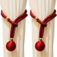 Red curtain tiebacks with gold accents on white curtains