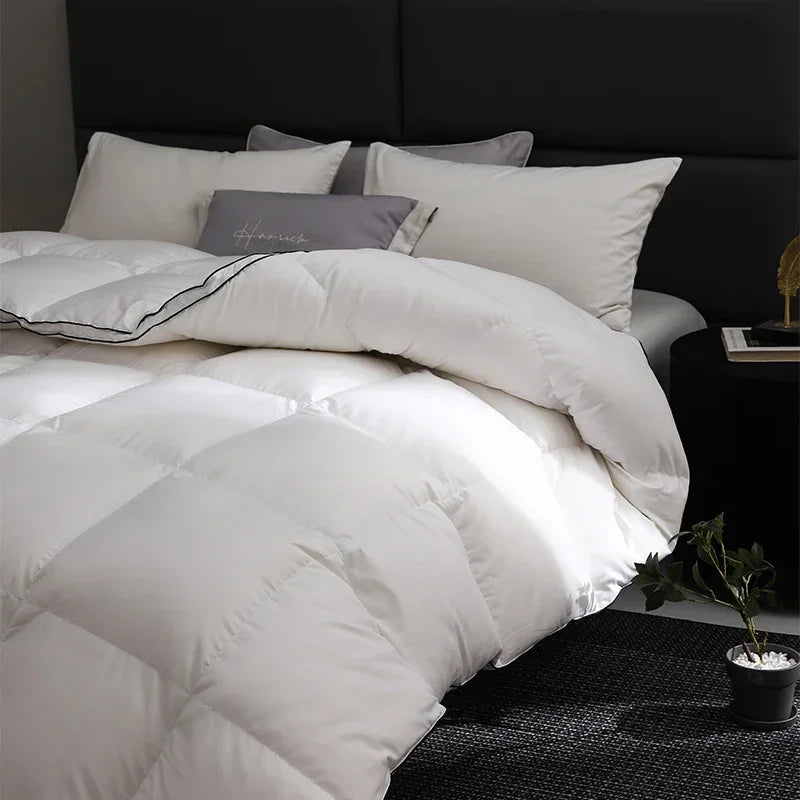 White comforter on a bed with pillows in a bedroom setting