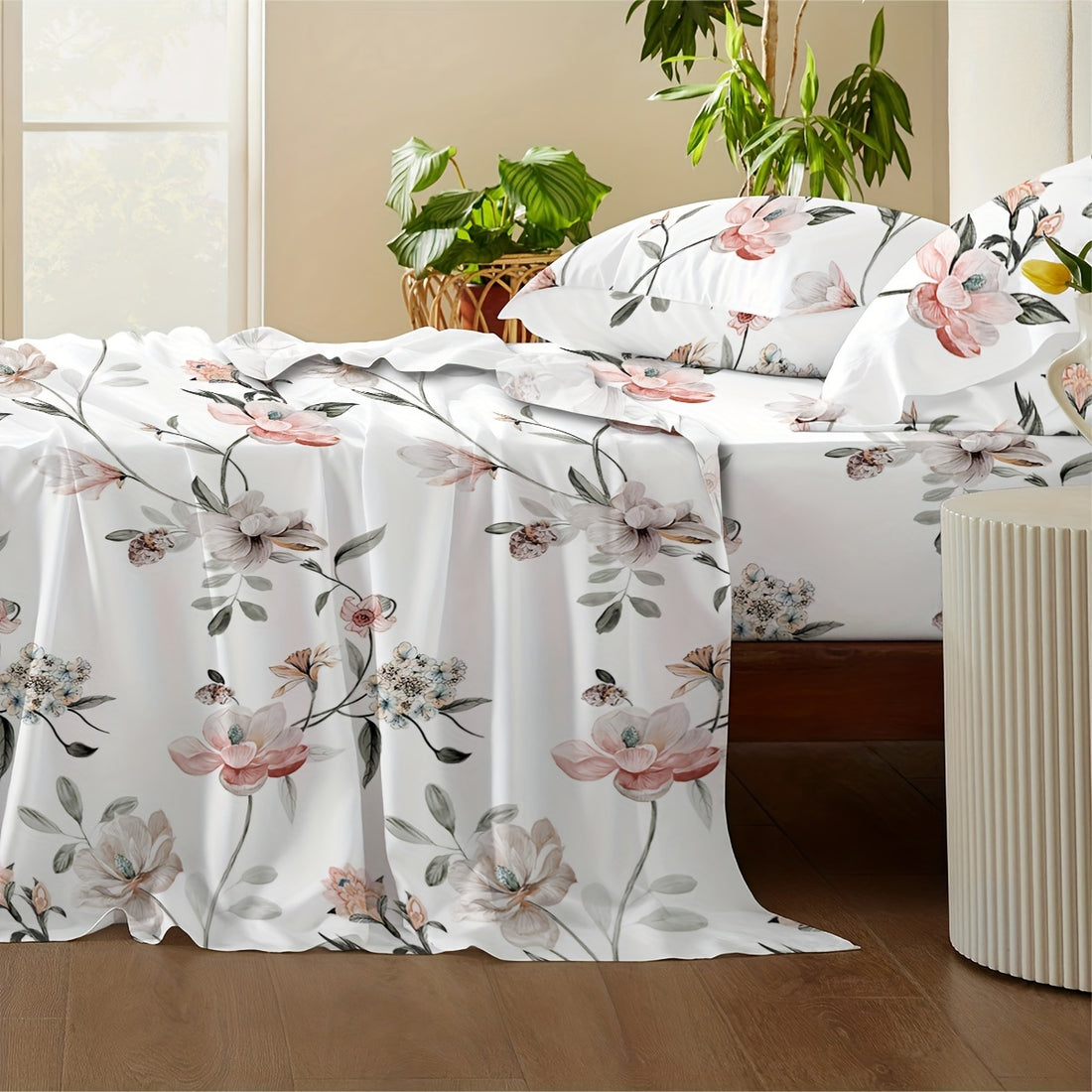 Floral-patterned bedspread on a bed with pillows in a room setting.