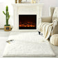 Living room with a white fireplace, armchair, and cactus plant.