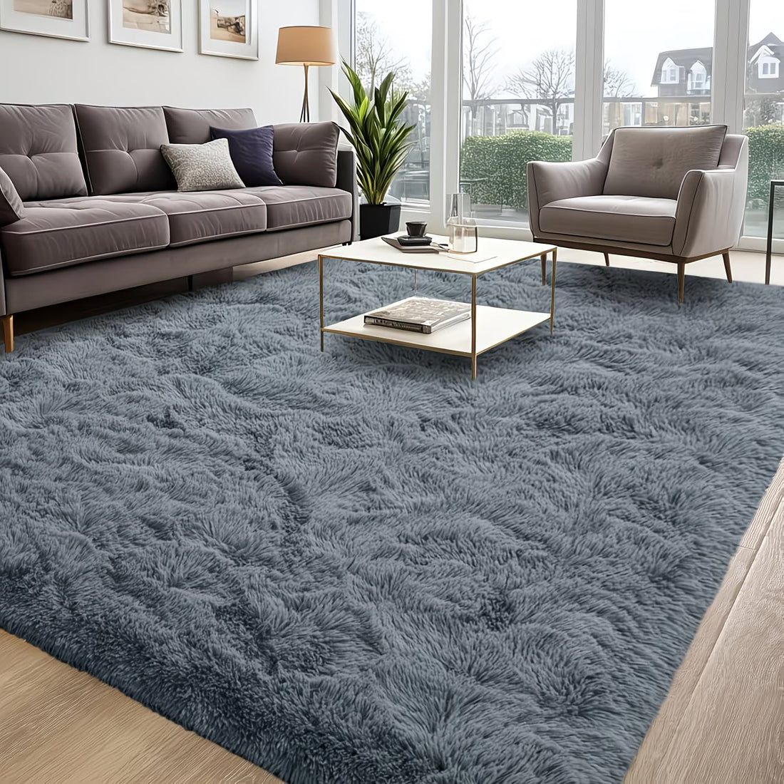 Living room with a large blue shaggy rug, gray sofa, and armchair.