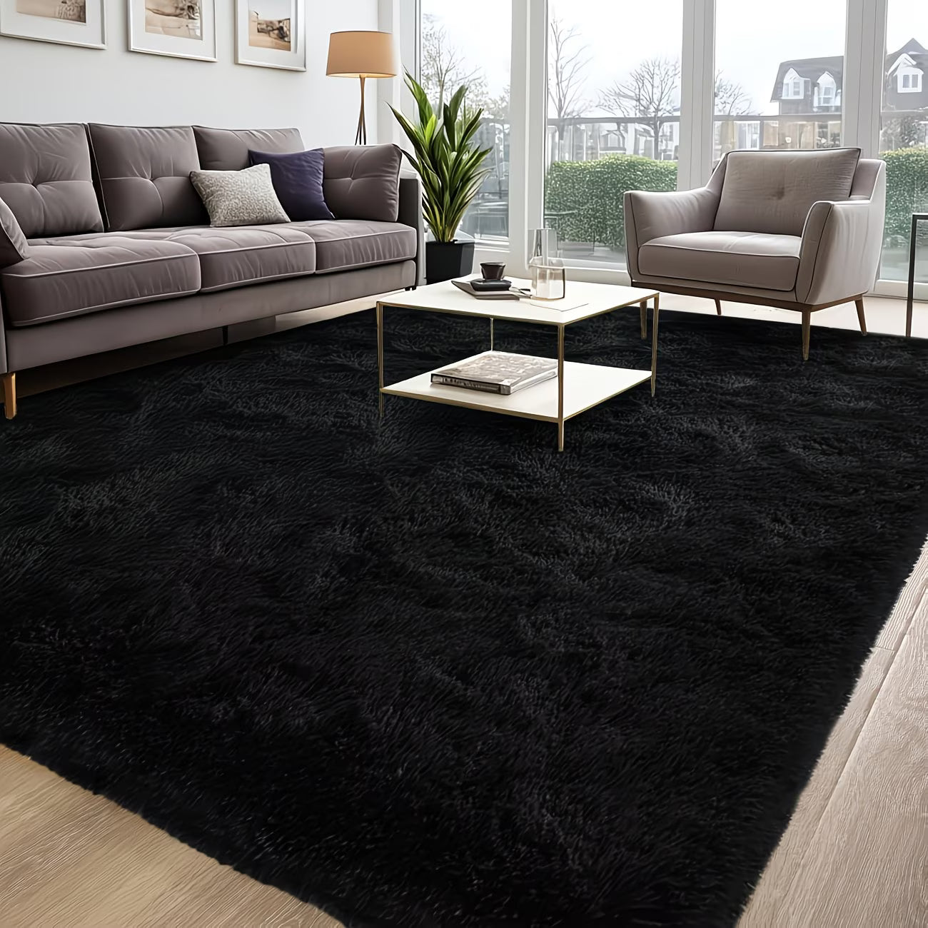 Modern living room with a black rug, gray sofa, and armchair.