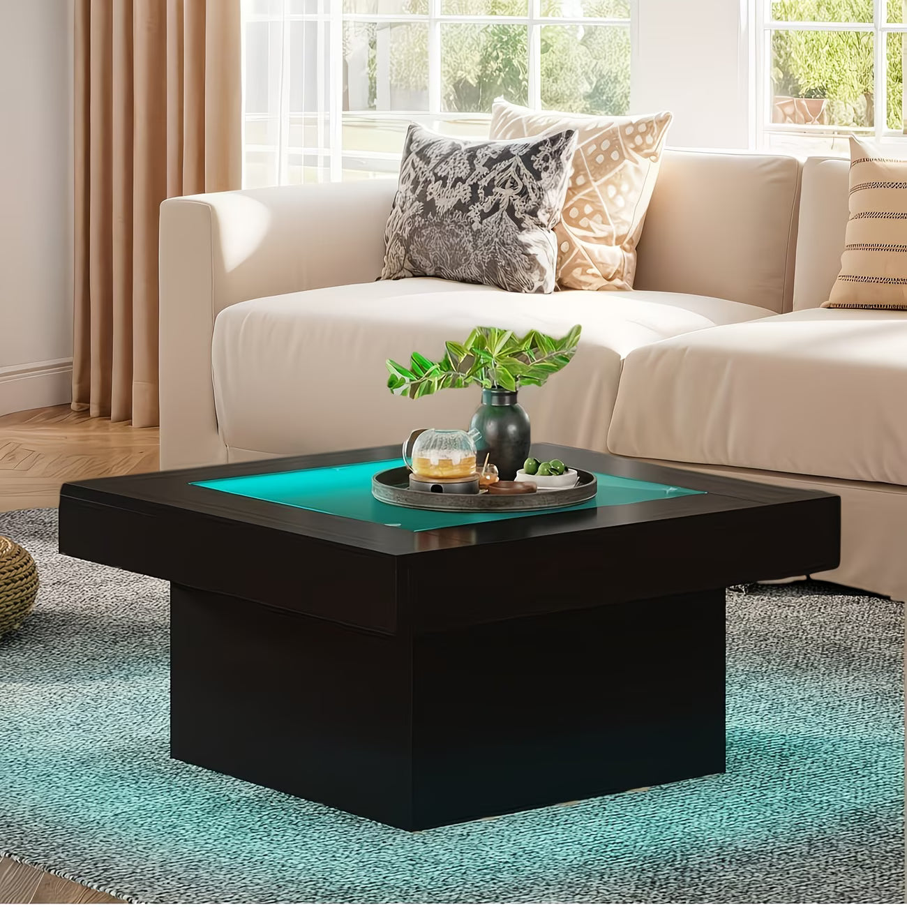 Modern living room with a black coffee table, beige sofa, and decorative pillows.
