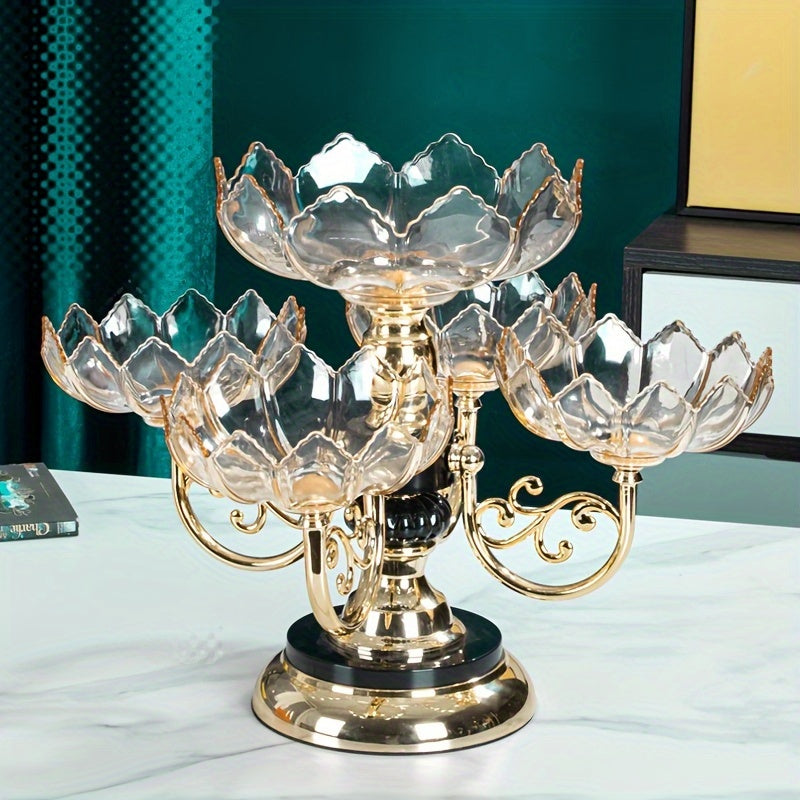 Decorative glass fruit bowl with gold accents on a white surface.