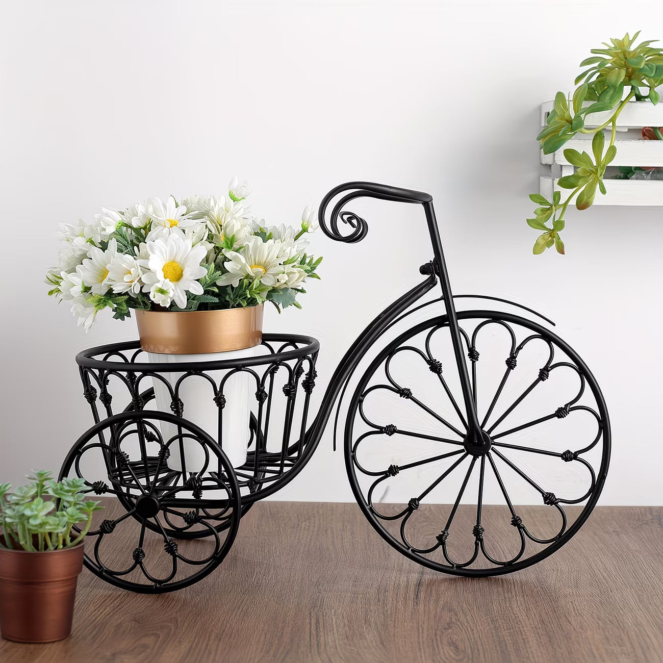 Decorative bicycle planter with flowers on a wooden floor