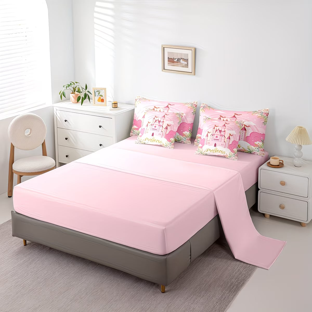 Bed with pink bedding and floral pillows in a bedroom setting.