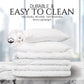 Stack of white bedding with text highlighting durability and ease of cleaning on a blurred background