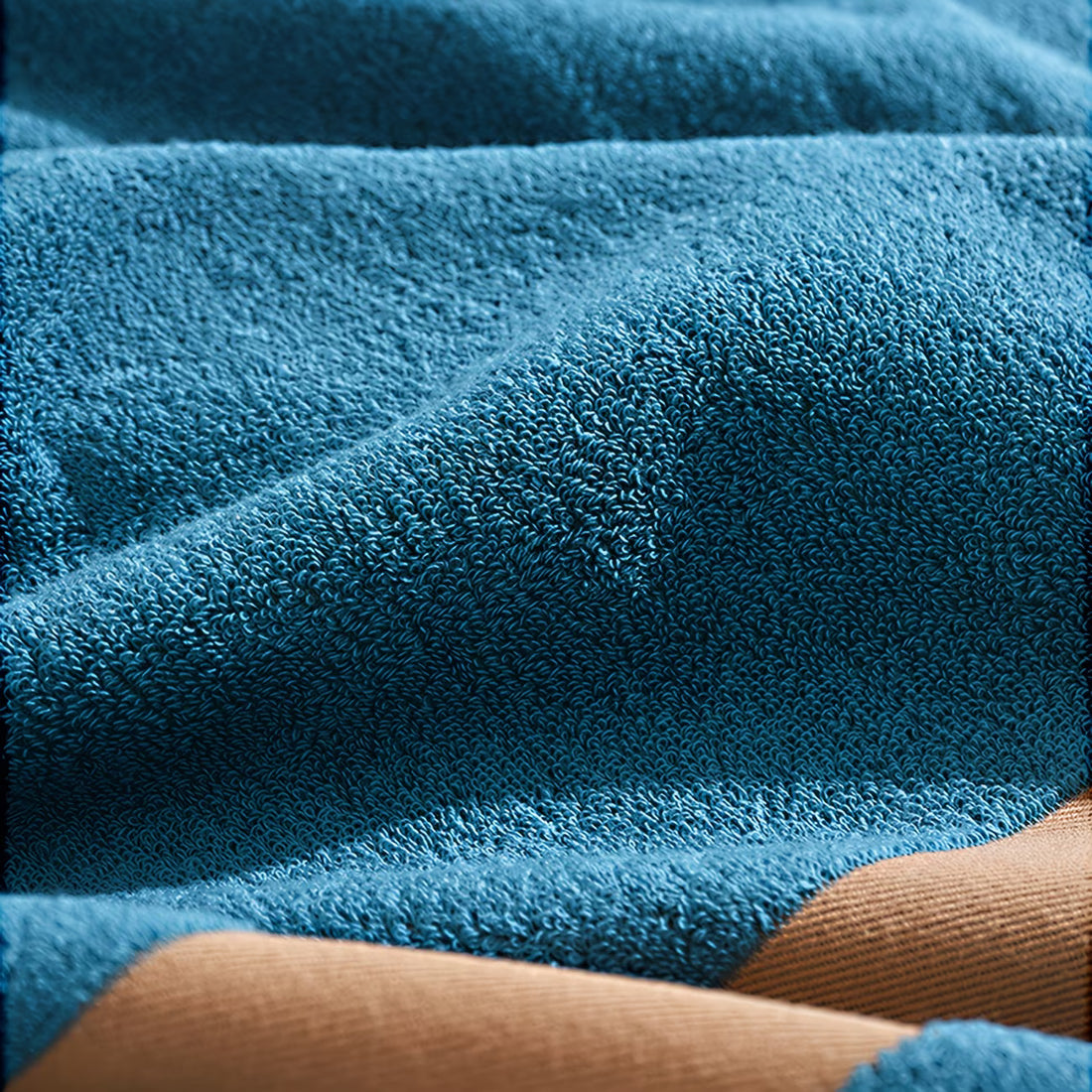 Close-up of a blue textured fabric with brown leather edges