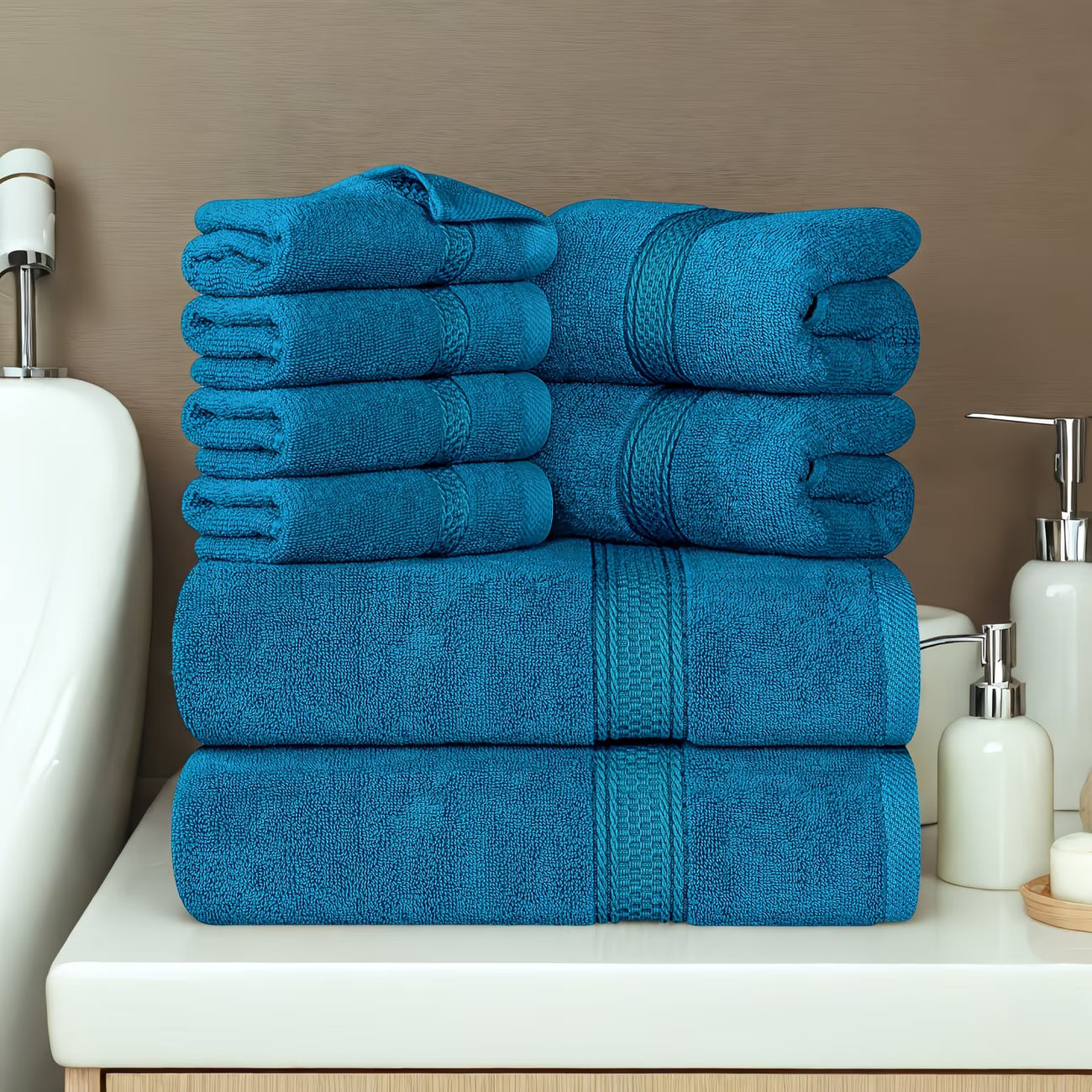 Stack of blue towels on a bathroom counter with neutral background