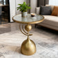Gold side table with a glass top in a living room setting