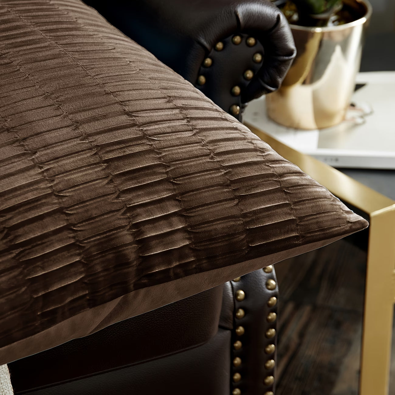 Brown textured pillow on a leather chair with a blurred background