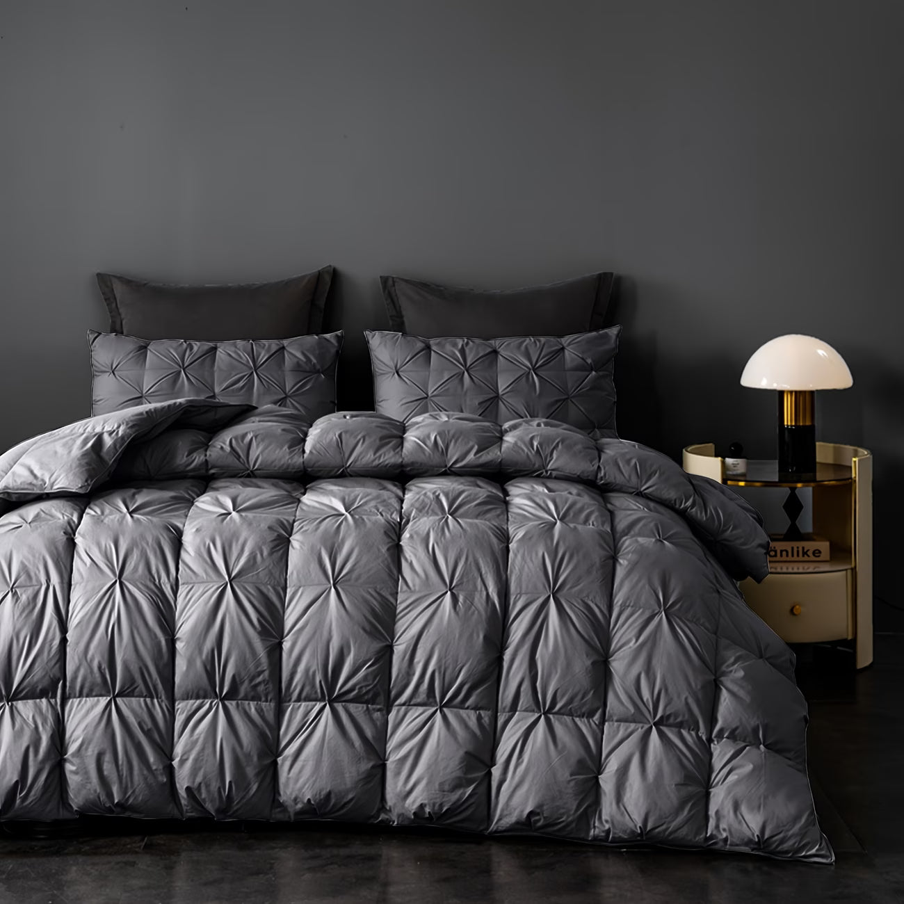Gray quilted comforter set on a bed 