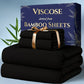 Black viscose bamboo sheets with a decorative box on a light blue background