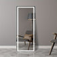 Full-length mirror with LED lighting in a room with a chair and lamp.