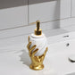 Decorative soap dispenser with gold base and white pump on a bathroom counter.