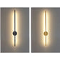 Two wall lights, one black and one gold, on a gray background.