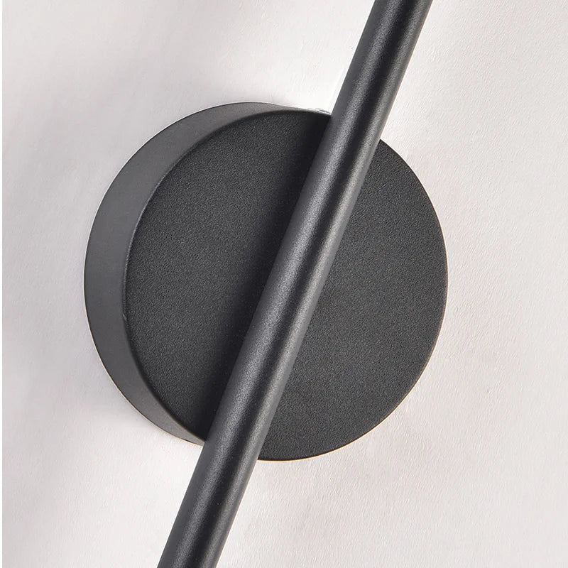 Black wall-mounted light fixture on a white background