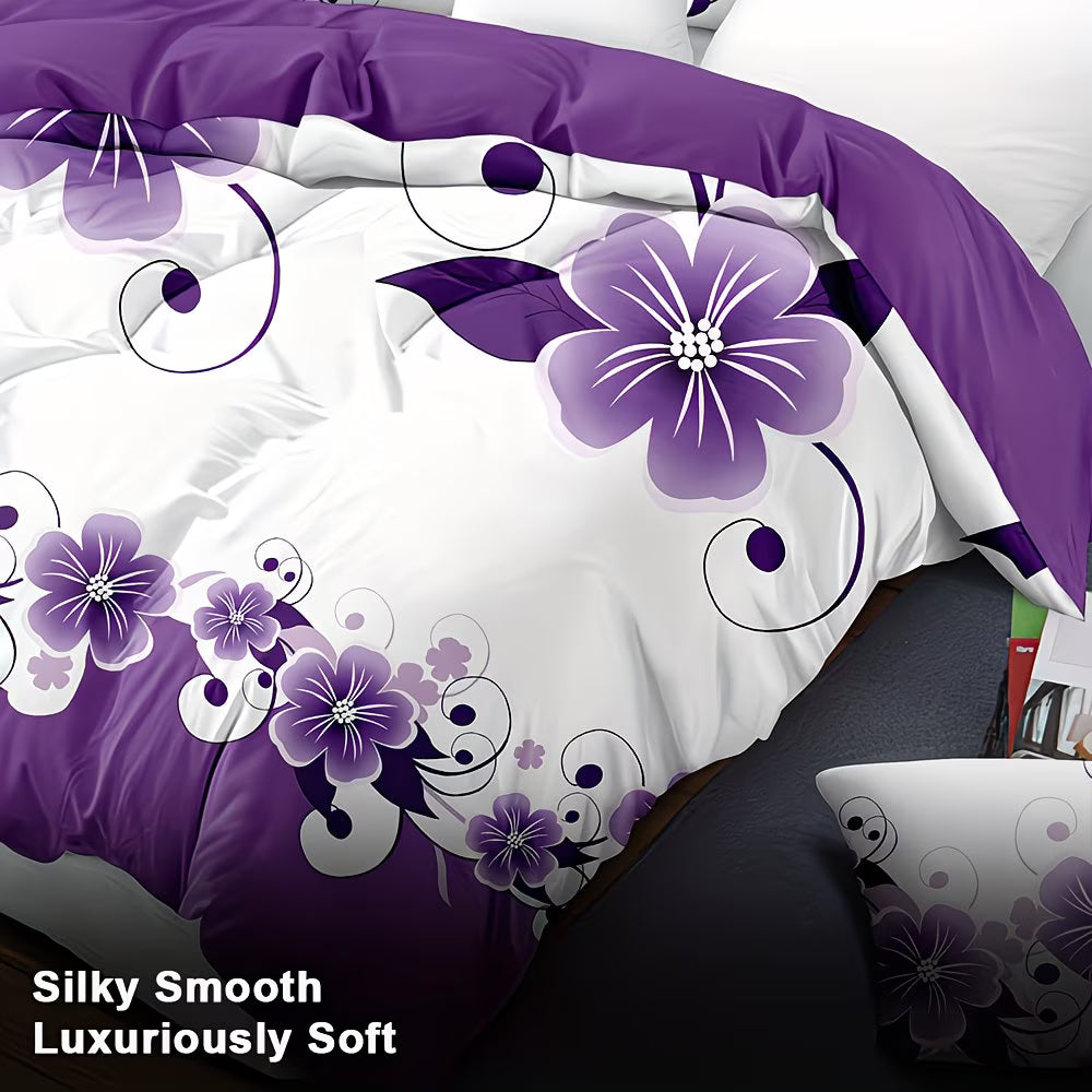 Purple floral bedding set on a bed with a laptop in the foreground.