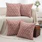 Pink textured throw pillows on a sofa in a living room setting.