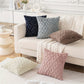 Decorative pillows on a white sofa in a living room setting.