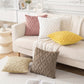 White sofa with patterned cushions in a living room setting
