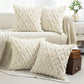 Decorative pillows with geometric patterns on a sofa in a living room setting.