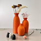 Three orange textured vases 