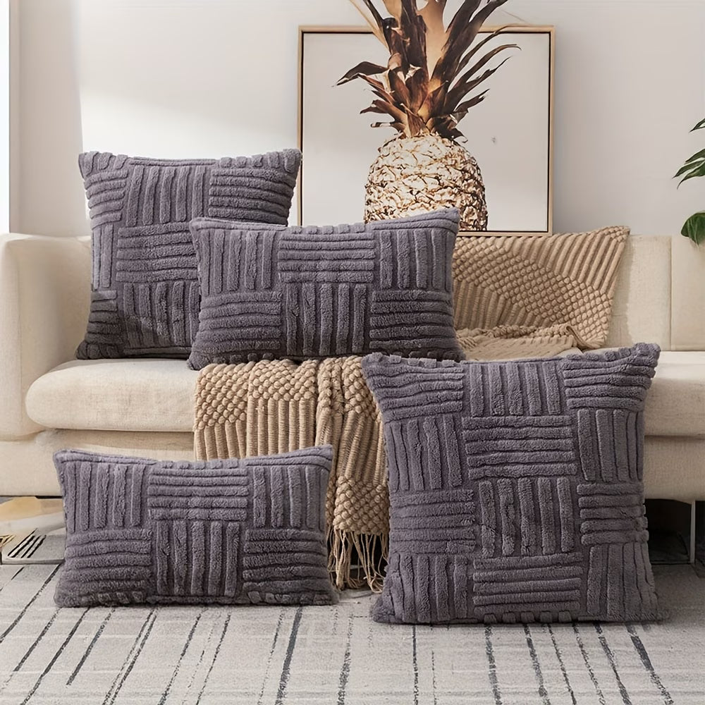 Gray textured pillows on a sofa with a pineapple decorative item in the background