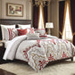 Decorative bedspread with red and gold patterns in a bedroom setting.
