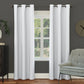 White curtains hanging in a room with a gray wall, window, and green chair.