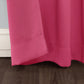 Close-up of a bright pink curtain on a wooden floor with a neutral wall background.
