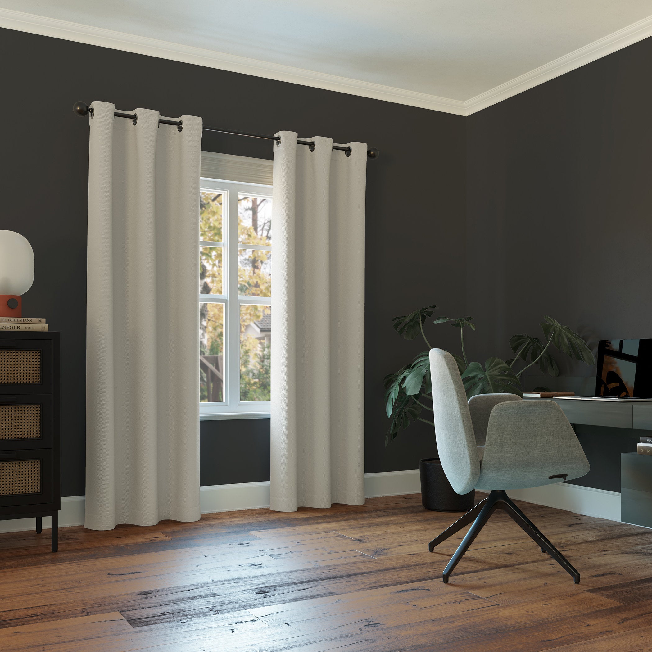 Modern room with dark gray walls, white curtains, a chair, and a window.